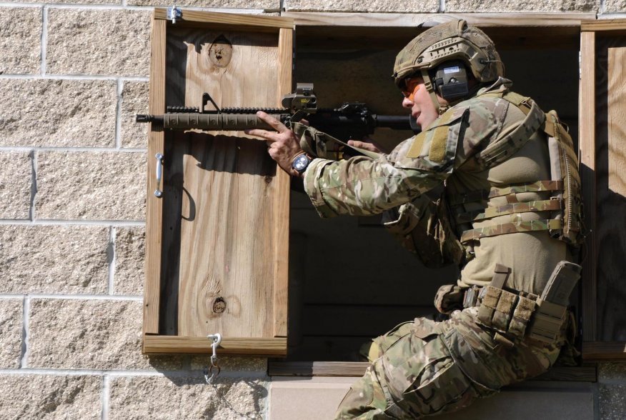 A Green Beret soldier fires a rifle during a stress shoot competition on Eglin Air Force Base, Fla., Oct. 15, 2015. U.S. Army photo by Staff Sgt. William Waller.