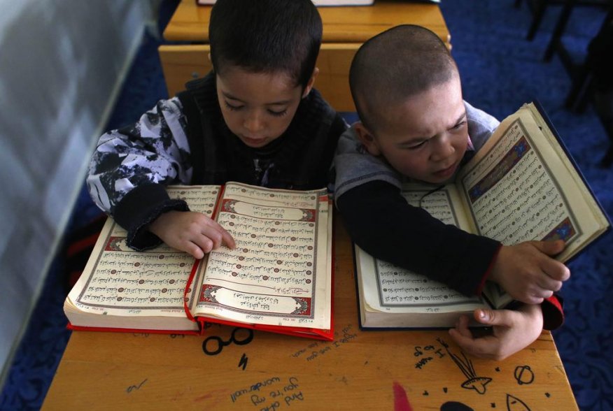 Uighur refugee boys read the Koran where they are housed in a gated complex in the central city of Kayseri, Turkey, February 11, 2015. REUTERS/Umit Bektas