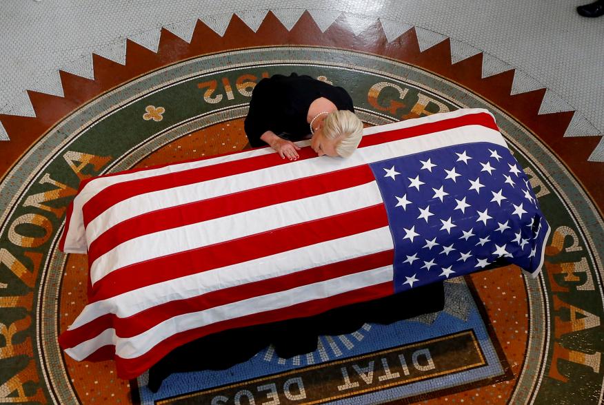 Cindy McCain, wife of U.S. Senator John McCain, touches the casket during a memorial service at the Arizona Capitol in Phoenix, Arizona, U.S., August 29, 2018. Ross D. Franklin/Pool via REUTERS