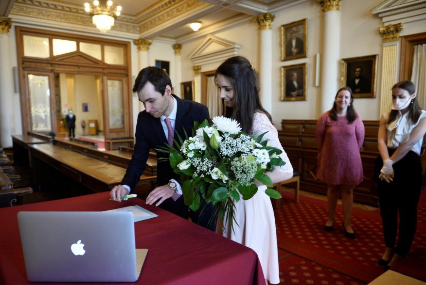 Roxanne, 25, a French lawyer working in Belgium, and Nicolas, 28, a real estate agent, attend their wedding ceremony despite the coronavirus disease (COVID-19) outbreak, in Brussels, Belgium April 11, 2020. Only the witnesses were allowed to the ceremony.