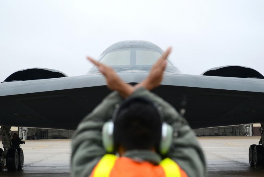 A crew chief from Whiteman Air Force Base, Mo., marshals in a B-2 Spirit stealth bomber at Whiteman Air Force Base, Mo., Jan 19, 2017 (U.S. Air Force photo by Senior Airman Joel Pfiester)