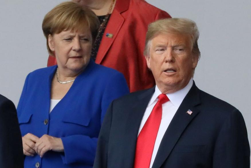 German Chancellor Angela Merkel and U.S. President Donald Trump are seen as they pose for a family photo at the start of the NATO summit in Brussels, Belgium July 11, 2018. REUTERS/Reinhard Krause