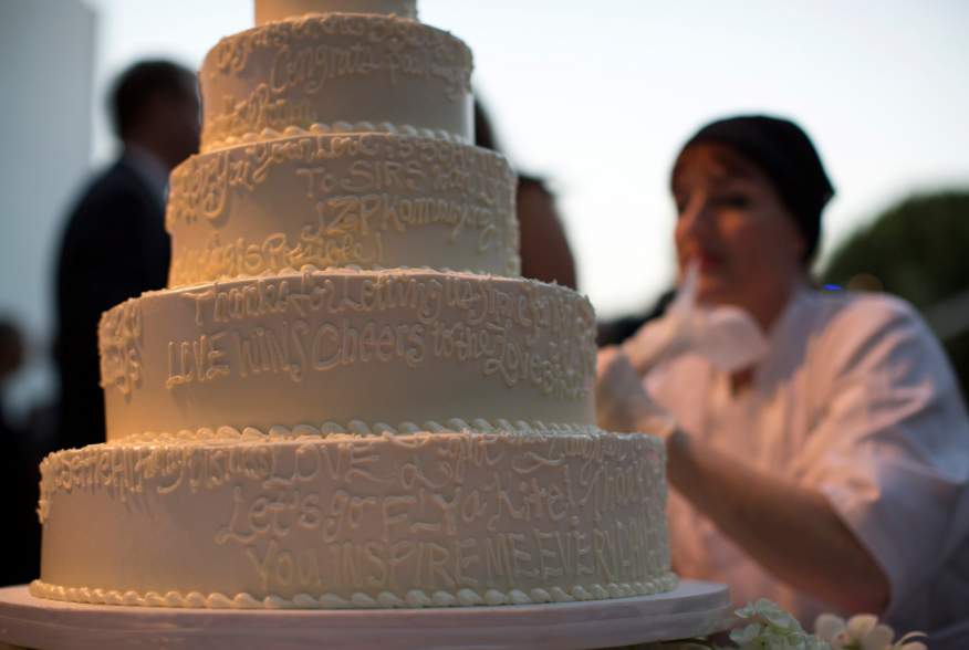 A wedding cake is decorated with messages from guests at a ceremony to celebrate the wedding of Paul Katami and Jeff Zarrillo at Beverly Hilton Hotel in Beverly Hills, California June 28, 2014. 