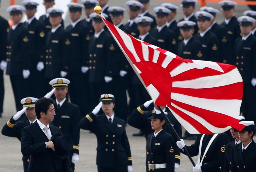 Japan's Prime Minister Shinzo Abe (L) reviews members of Japan Self-Defense Force (JSDF) during the JSDF Air Review, to celebrate 60 years since the service's founding at Hyakuri air base in Omitama, northeast of Tokyo October 26, 2014. About 740 personne