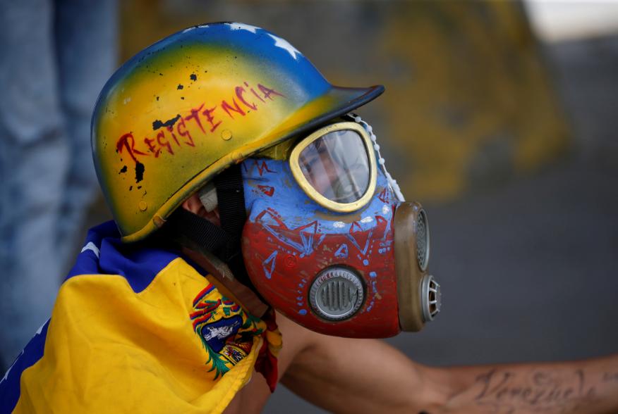 A demonstrator looks on while clashing with riot security forces during a rally against Venezuela's President Nicolas Maduro's government in Caracas, Venezuela, August 12, 2017. REUTERS/Andres Martinez Casares 