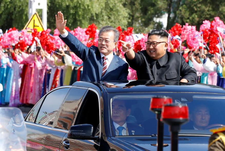 South Korean President Moon Jae-in and North Korean leader Kim Jong Un wave during a car parade in Pyongyang, North Korea, September 18, 2018. Pyeongyang Press Corps/Pool via REUTERS