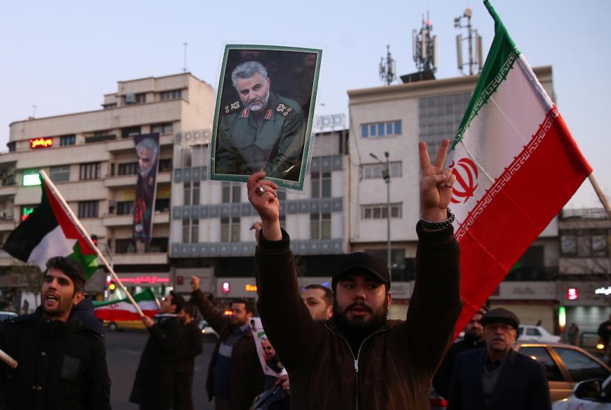 A man holds a picture of late Iranian Major-General Qassem Soleimani, as people celebrate in the street after Iran launched missiles at U.S.-led forces in Iraq, in Tehran, Iran January 8, 2020. Nazanin Tabatabaee/WANA (West Asia News Agency) via REUTERS