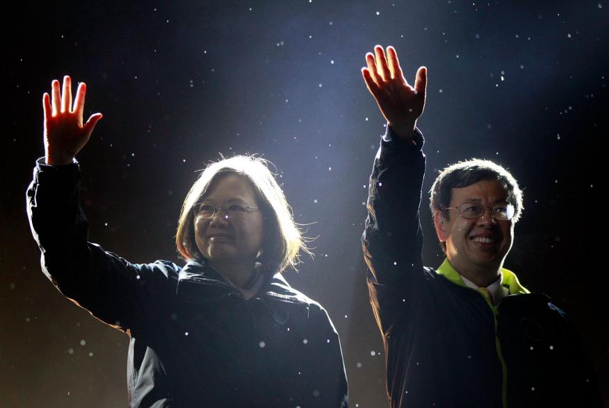 Taiwan's Democratic Progressive Party (DPP) Chairperson and presidential candidate Tsai Ing-wen (L) and vice presidential candidate Chen Chien-jen greet supporters as they take the stage during a final campaign rally ahead of the elections in Taipei, Taiw