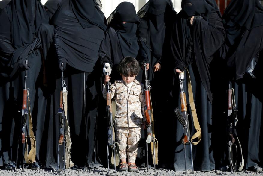 A boy stands with women loyal to the Houthi movement during a gathering held to show their support to the movement in Sanaa, Yemen January 14, 2018. REUTERS/Khaled Abdullah TPX IMAGES OF THE DAY