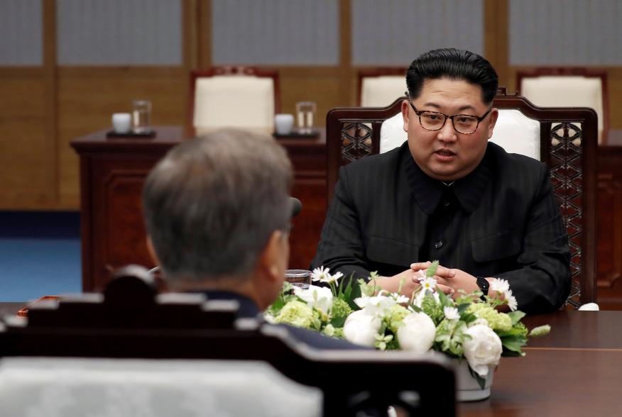 North Korean leader Kim Jong Un talks to South Korean President Moon Jae-in during their meeting at the Peace House at the truce village of Panmunjom inside the demilitarized zone separating the two Koreas, South Korea, April 27, 2018.