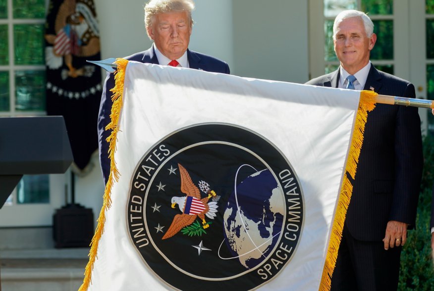 U.S. President Donald Trump stands behind a U.S. Space Command flag with Vice President Mike Pence at an event to officially launch the United States Space Command in the Rose Garden of the White House in Washington, U.S., August 29, 2019. REUTERS/Kevin L