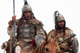 Horse-mounted members of the Mongolian Armed Forces honor their warrior heritage during the opening ceremony of exercise Khaan Quest, Five Hills Training Center, Mongolia. 1 Aug 2007. (Official U. S. Marine Corps photo by Sgt. G. S. Thomas)