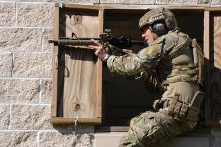 A Green Beret soldier fires a rifle during a stress shoot competition on Eglin Air Force Base, Fla., Oct. 15, 2015. U.S. Army photo by Staff Sgt. William Waller.