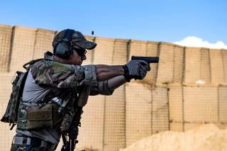 An Air Force pararescueman fires his Glock 9 mm handgun during weapons training at Bagram Airfield, Afghanistan, Feb. 21, 2018. Air Force photo by Tech. Sgt. Gregory Brook