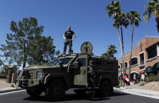 A Maricopa County, Arizona police SWAT team with an armored vehicle stand guard outside a campaign rally being held by Republican U.S. presidential candidate Donald Trump in Fountain Hills, Arizona March 19, 2016. REUTERS/Ricardo Arduengo