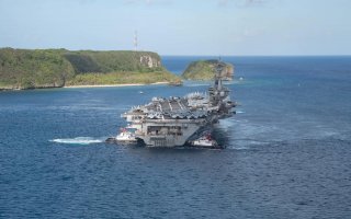 The U.S. Navy aircraft carrier USS Theodore Roosevelt departs following an extended visit in the midst of a coronavirus disease (COVID-19) outbreak, from Apra Harbor, Guam May 21, 2020. Picture taken May 21, 2020. U.S. Navy/Mass Communication Specialist S