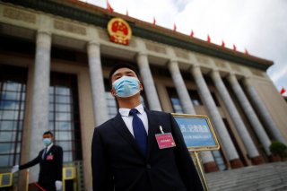 Security personnel wearing face masks following the coronavirus disease (COVID-19) outbreak stand guard outside the Great Hall of the People before the second plenary session of the National People's Congress (NPC) in Beijing, China May 25, 2020. REUTERS/