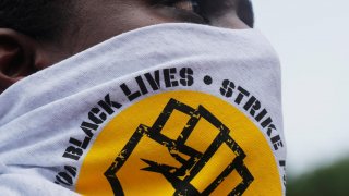 SEIU 32BJ union worker Dalida Rocha takes part in a nationwide Strike for Black Lives, protesting against racial inequality in the aftermath of the death in Minneapolis police custody of George Floyd, in Boston, Massachusetts, U.S., July 20, 2020. REUTERS