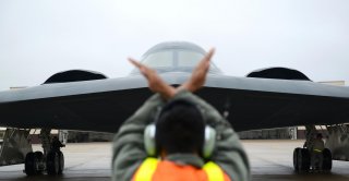 A crew chief from Whiteman Air Force Base, Mo., marshals in a B-2 Spirit stealth bomber at Whiteman Air Force Base, Mo., Jan 19, 2017 (U.S. Air Force photo by Senior Airman Joel Pfiester)