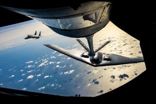 A B-2 Spirit Stealth Bomber from the 509th Bomb Wing, Whiteman Air Force Base, Missouri, flies behind a KC-135 Stratotanker from the 100th Air Refueling Wing, RAF Mildenhall, England, during a training mission for Bomber Task Force Europe over England on 