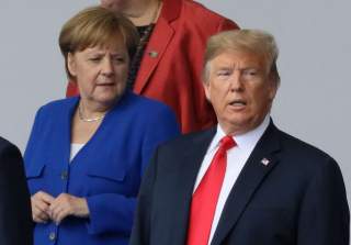 German Chancellor Angela Merkel and U.S. President Donald Trump are seen as they pose for a family photo at the start of the NATO summit in Brussels, Belgium July 11, 2018. REUTERS/Reinhard Krause