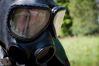 Spc. Carl Best from Lincolnshire, Ill., and is a intelligence analyst with the 378th Military Intelligence Battalion representing the Military Intelligence Readiness Command, puts on his Mission Oriented Protective Posture suit and mask, during the warrio