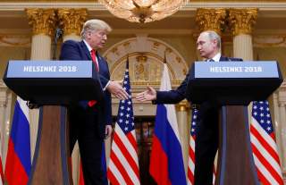 U.S. President Donald Trump and Russia's President Vladimir Putin shake hands during a joint news conference after their meeting in Helsinki, Finland, July 16, 2018. REUTERS/Kevin Lamarque