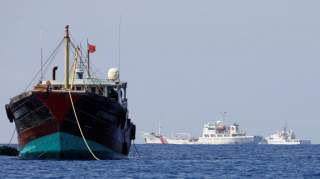 China Coast Guard vessels patrol past a Chinese fishing vessel at the disputed Scarborough Shoal, April 5, 2017. Picture taken April 5, 2017. REUTERS/Erik De Castro