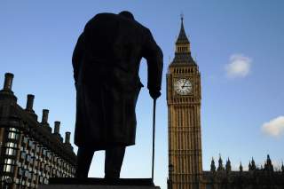 The statue of Britain's former Prime Minister Winston Churchill is silhouetted in front of the Houses of Parliament in London.