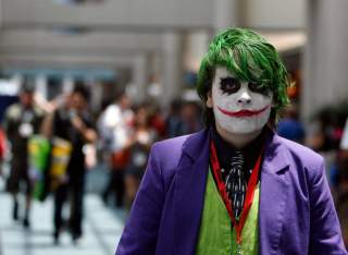 A visitor dressed like the Joker character from the movie 