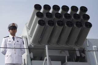 A Chinese People's Liberation Army (PLA) Navy personnel stands on the deck of the Chinese naval guided missile destroyer Haikou (171) during a welcome ceremony as it docks at the Ngong Shuen Chau Naval Base in Hong Kong April 30, 2012.