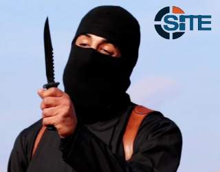 A masked, black-clad militant, who has been identified by the Washington Post newspaper as a Briton named Mohammed Emwazi, brandishes a knife in this still image from a 2014 video obtained from SITE Intel Group February 26, 2015.