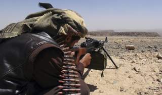 A Southern Movement militant takes aim with his machine gun as he takes part in the securing of the Jabal al-Ierr area against Shi'ite Houthi fighters, in Yemen's southern Lahej province March 7, 2015. Most of Yemen has been left without state services or