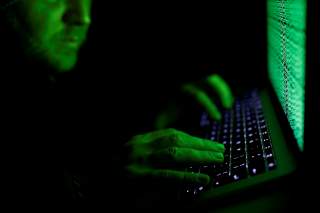 A man types on a computer keyboard in front of the displayed cyber code in this illustration picture taken on March 1, 2017. REUTERS/Kacper Pempel/Illustration