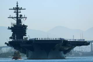 The aircraft carrier USS Theodore Roosevelt, with sailors manning the rails, leaves port on deployment to the western Pacific Ocean and Persian Gulf from San Diego, California, U.S., October 6, 2017. REUTERS/Mike Blake