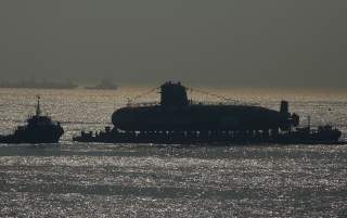 India's third Scorpene-class submarine INS Karanj is seen silhouetted as a tugboat pulls it during its launch at the Mazagon Dock Ltd. naval shipbuilding yard, in Mumbai, India January 31, 2018. REUTERS/Shailesh Andrade TPX IMAGES OF THE DAY