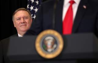 U.S. President Donald Trump is watched by Secretary of State Mike Pompeo as they take part in the swearing-in ceremony for the Central Intelligence Agency's first female director, Gina Haspel, at CIA Headquarters in Langley, Virginia, U.S., May 21, 2018. 