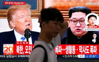 A man walks past a TV broadcasting a news report on the dismantling of the Punggye-ri nuclear testing site, in Seoul, South Korea, May 24, 2018. REUTERS/Kim Hong-Ji