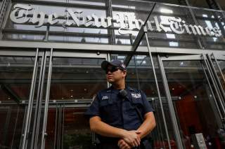 A New York Police officer is seen deployed outside the New York Times building following a fatal shooting at a Maryland newspaper, in New York City, U.S., June 28, 2018. REUTERS/Brendan McDermid