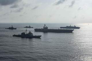 The Ronald Reagan Strike Group ship's the aircraft carrier USS Ronald Reagan (CVN 76), the guided-missile cruiser USS Antietam (CG 54) and the guided-missile destroyer USS Milius (DDG 69) conduct a photo exercise with the Japan Maritime Self-Defense Force