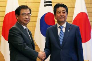 Japan's Prime Minister Shinzo Abe shakes hands with South Korea's National Intelligence Service chief Suh Hoon before their meeting at Abe's official residence in Tokyo, Japan September 10, 2018. Koji Sasahara/Pool via Reuters