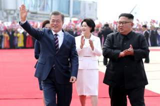 South Korean President Moon Jae-in and North Korean leader Kim Jong Un attend an official welcome ceremony at Pyongyang Sunan International Airport, in Pyongyang, North Korea, September 18, 2018. Pyeongyang Press Corps/Pool via REUTERS