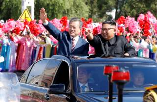 South Korean President Moon Jae-in and North Korean leader Kim Jong Un wave during a car parade in Pyongyang, North Korea, September 18, 2018. Pyeongyang Press Corps/Pool via REUTERS