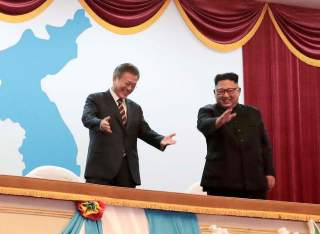 South Korean President Moon Jae-in talks with North Korean leader Kim Jong Un as they watch an art performance at Pyongyang Grand Theatre in Pyongyang, North Korea, September 18, 2018. Pyeongyang Press Corps/Pool via REUTERS