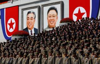 Senior military officials watch a parade as portraits of late North Korean leaders Kim Il Sung and Kim Jong Il are seen in the background at the main Kim Il Sung square in Pyongyang, North Korea, September 9, 2018. REUTERS/Danish Siddiqui SEARCH 