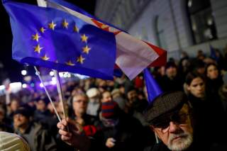 FILE PHOTO: People in front of the Presidential Palace during a protest against judicial reforms in Warsaw, Poland, November 24, 2017. REUTERS/Kacper Pempel/File Photo