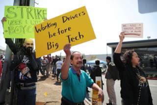 Striking Uber and Lyft drivers protest Uber's decision to cut per-mile pay from 80 cents to 60 cents, outside the Uber Hub in Redondo Beach, California, U.S., March 25, 2019. REUTERS/Lucy Nicholson