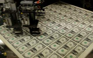 FILE PHOTO: United States one dollar bills get rotated before being cut into individual pieces during production at the Bureau of Engraving and Printing in Washington November 14, 2014. REUTERS/Gary Cameron/File Photo