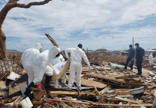 Members of the Bahamian Defense Force remove bodies from the destroyed Abaco shantytown called Pigeon Peas, after Hurricane Dorian in Marsh Harbour, Bahamas September 8, 2019. Picture taken September 8, 2019. REUTERS/Zach Fagenson