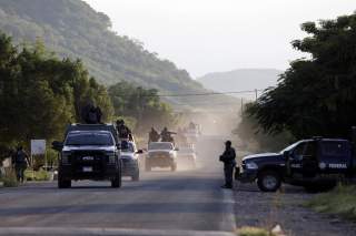 Security forces patrol along a road after police officers were killed during an ambush by suspected cartel hitmen in El Aguaje, in Michoacan state, Mexico October 14, 2019. REUTERS/Alan Ortega